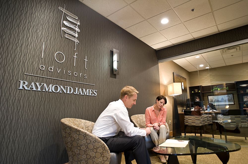 Loft advisor employee cheerfully greets a customer in the lobby